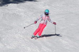 Mädchen mit pinker Hose beim Skifahren