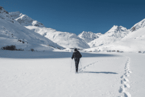 einsamer Schneeschuhwanderer vor Bergen