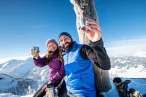 Wanderer trinken auf Berggipfel heißes Getränk