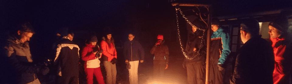 Gruppe steht ums Feuer